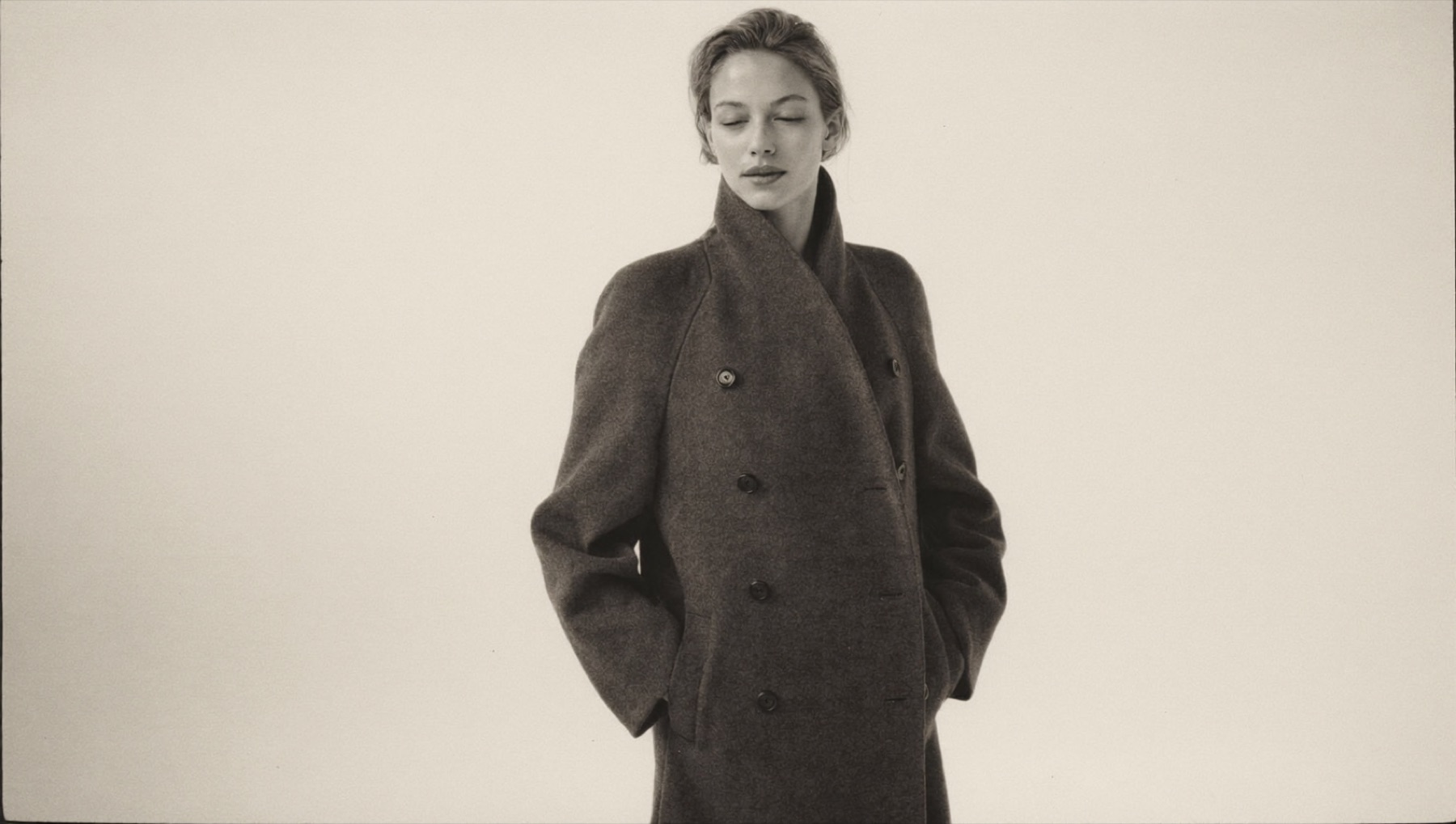 A woman in a long charcoal double-face wool coat
